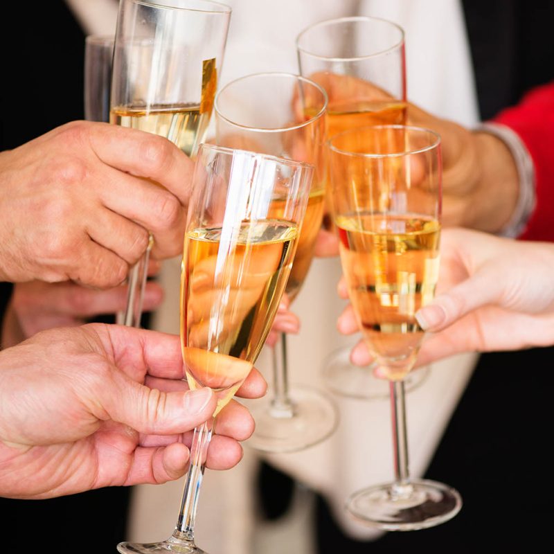 Business people clinking champagne making a toast at party