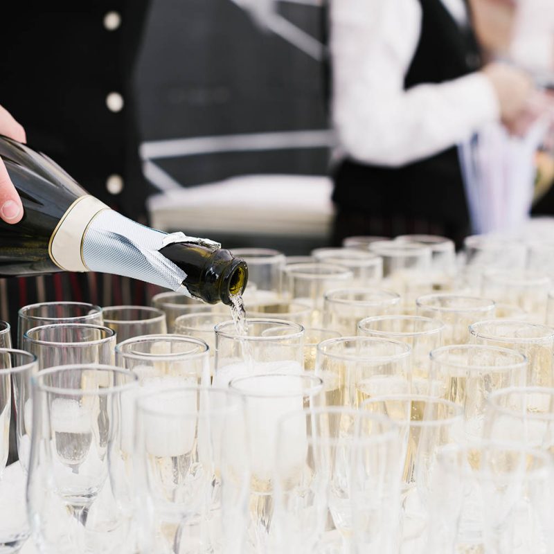 waiter-pouring-champagne-into-glasses